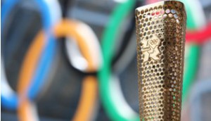 Copied from Playback - The London Organising Committee of the Olympic and Paralympic Games (LOCOG) today showcases prototypes of the London 2012 Olympic Torch to be carried by 8,000 inspirational Torchbearers.The winning design connects the London 2012 Olympic Torch Relay to each of the 8,000 Torchbearers and their community. The Torch's triangular, gold-coloured form is perforated by 8,000 circles representing the 8,000 Torchbearers and their stories of personal achievement and/or contribution to their local community which will be celebrated during the London 2012 Olympic Torch Relay.